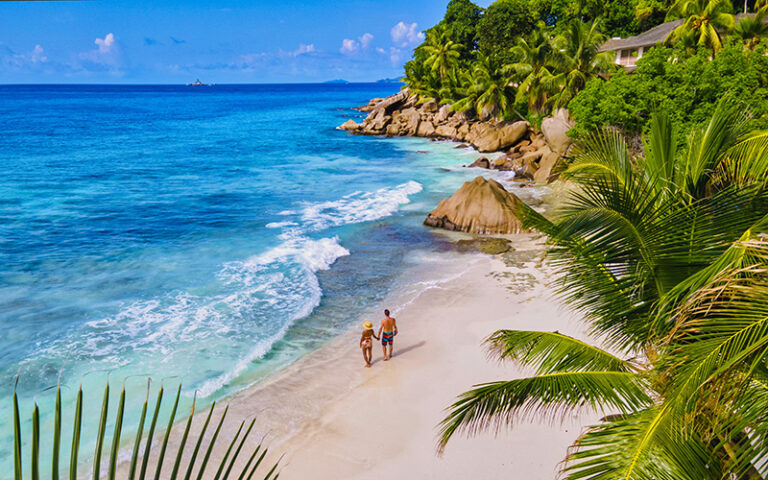 Anse Patates beach, La Digue Island, Seyshelles, Drone aerial view of La Digue Seychelles bird eye view.of tropical Island. mature couple men and women on vacation in Seychelles