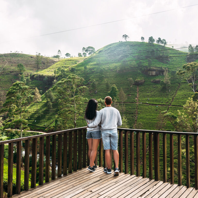 Couple in love at tea plantation. Travel to Sri Lanka. Green tea plantations in the mountains. Guy and girl traveling around Asia. Man and woman traveling. Tea plantations in Sri Lanka. Loving couple