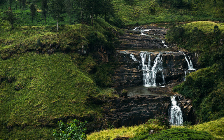 Waterfall among the green mountains. Waterfalls Of Sri Lanka. Landscapes Of Asia. Aerial photography. Tea plantation. Green hill. Mountain river. Small waterfall. Sri lanka